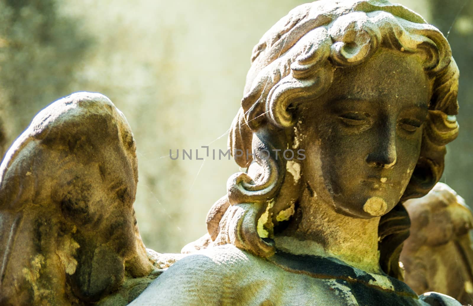 detail of a mourning sculpture on a cemetery