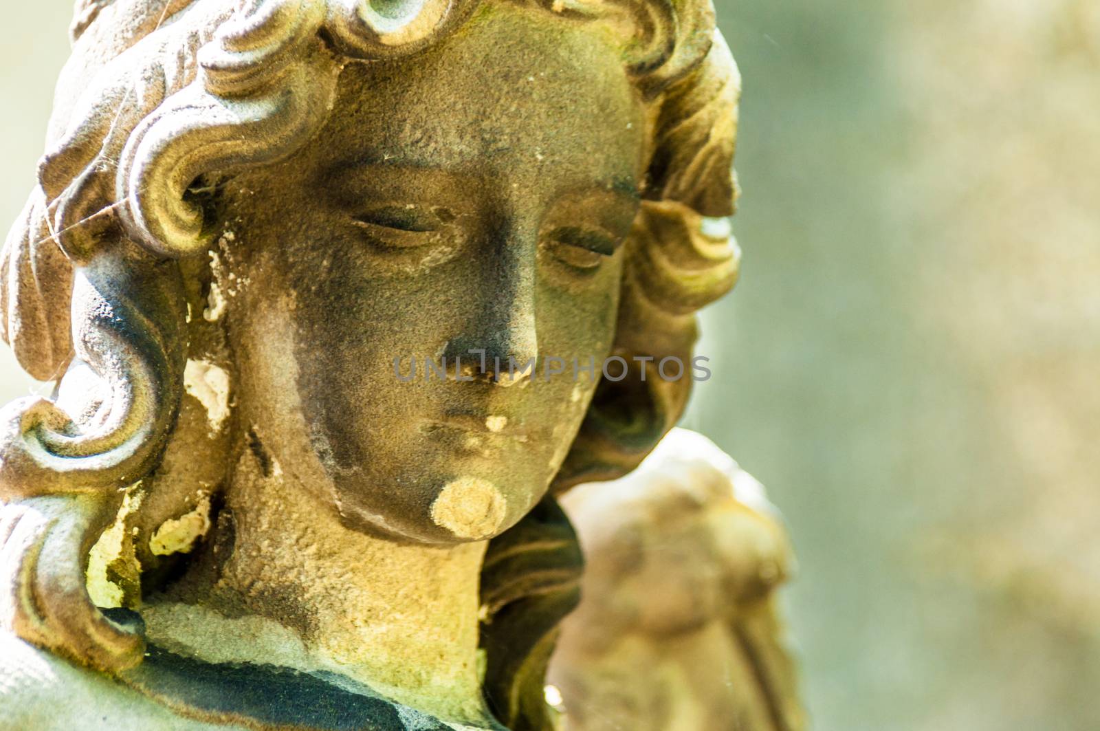 detail of a mourning sculpture on a cemetery