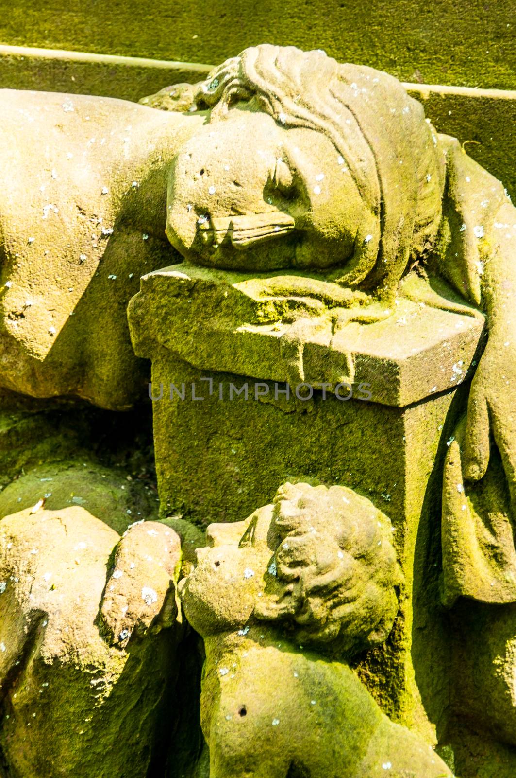 detail of a mourning sculpture on a cemetery