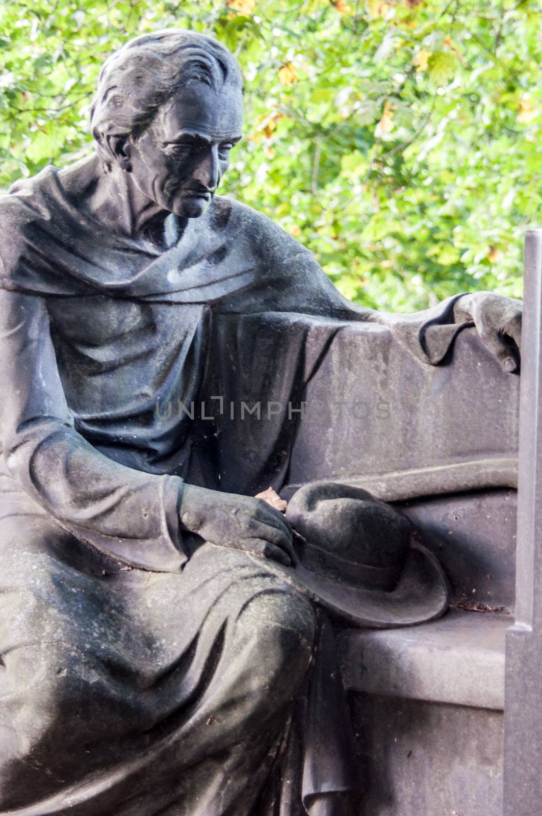 detail of a mourning sculpture on a cemetery