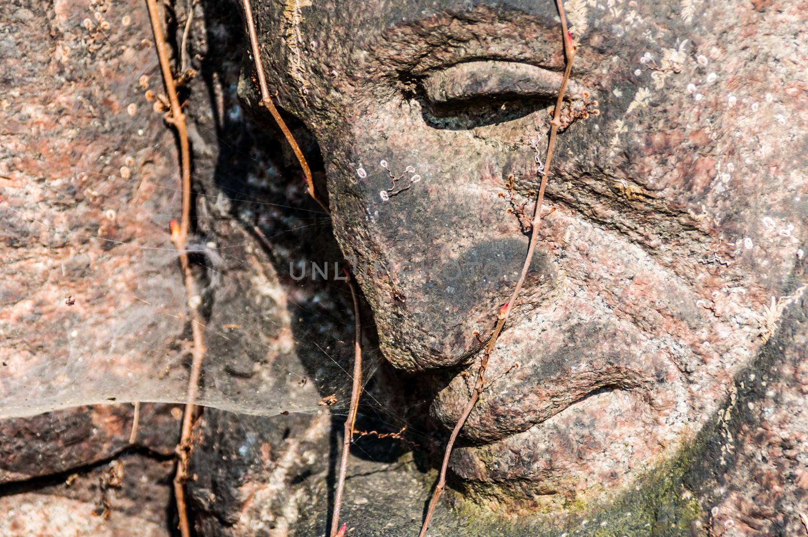 detail of a mourning sculpture on a cemetery