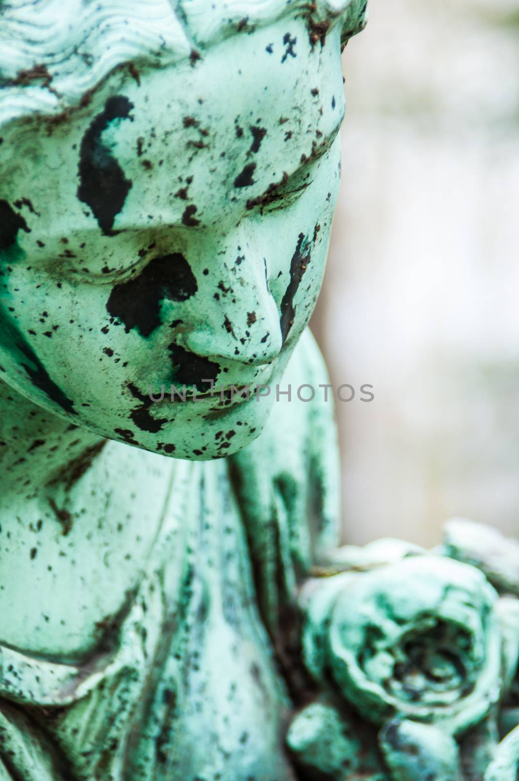 detail of a mourning sculpture on a cemetery