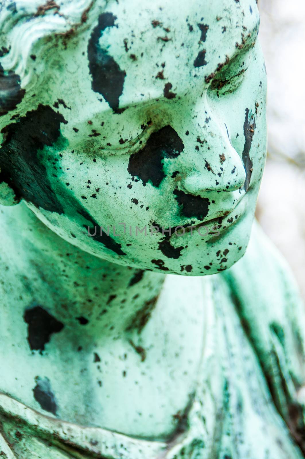 detail of a mourning sculpture on a cemetery