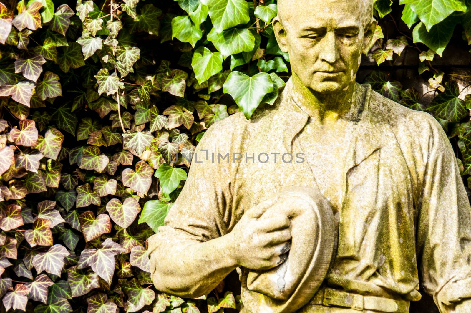 detail of a mourning sculpture on a cemetery