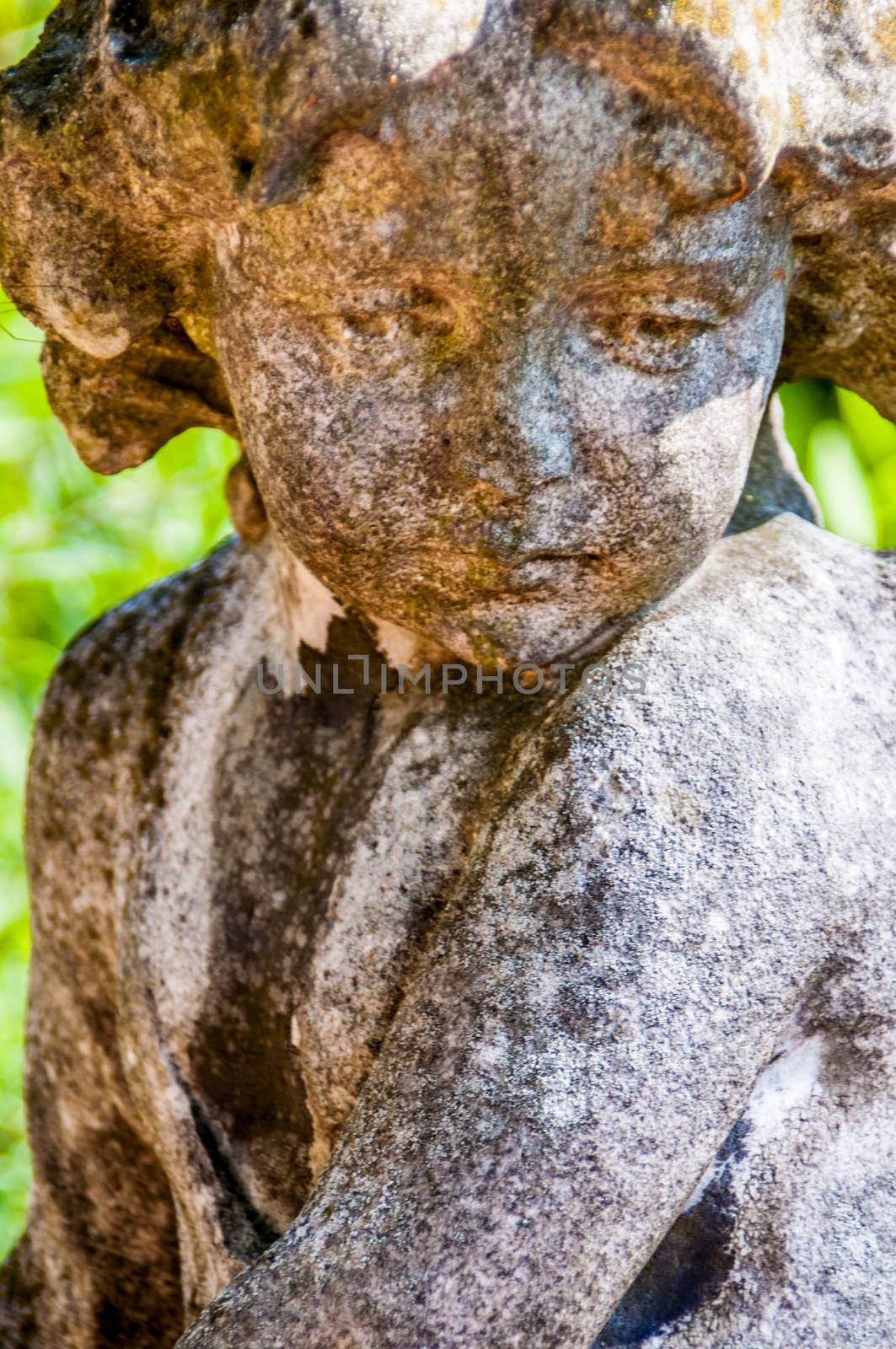 detail of a mourning sculpture on a cemetery