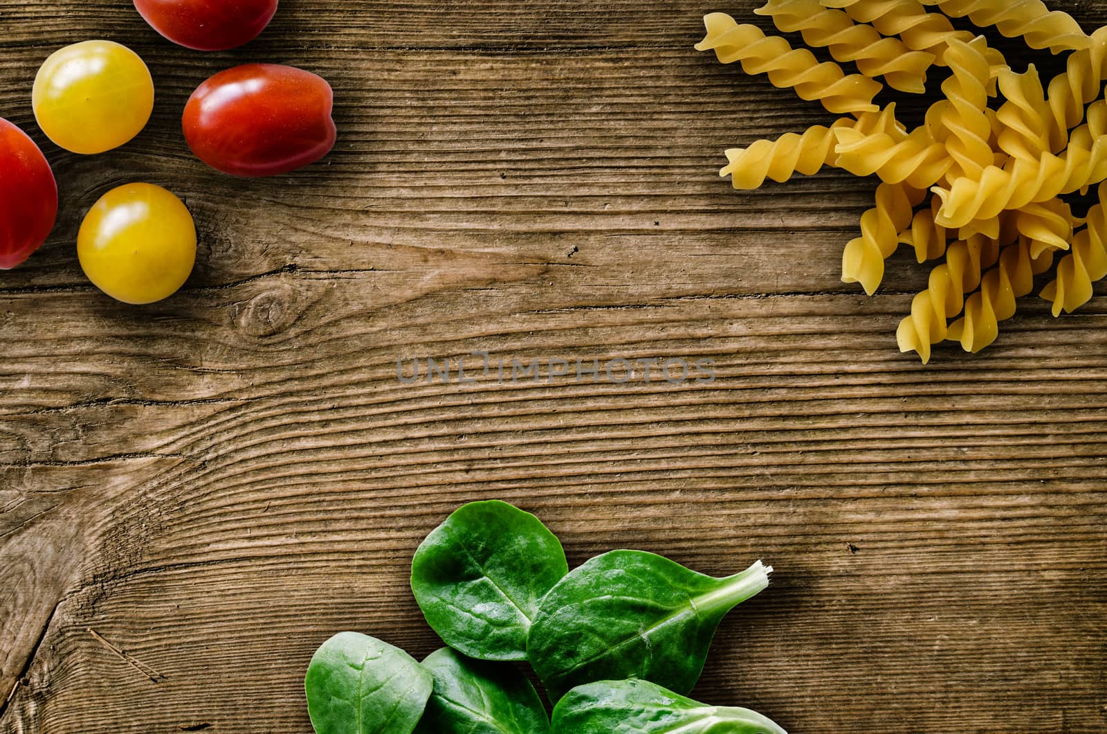 Retro FIlter Photo Of Pasta Salad Leaves And Cherry Tomatoes On A Rustic Wooden Table With Copy Space