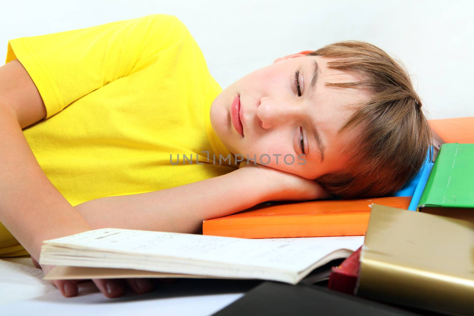 Sad and Tired Kid with the Books on the Bed