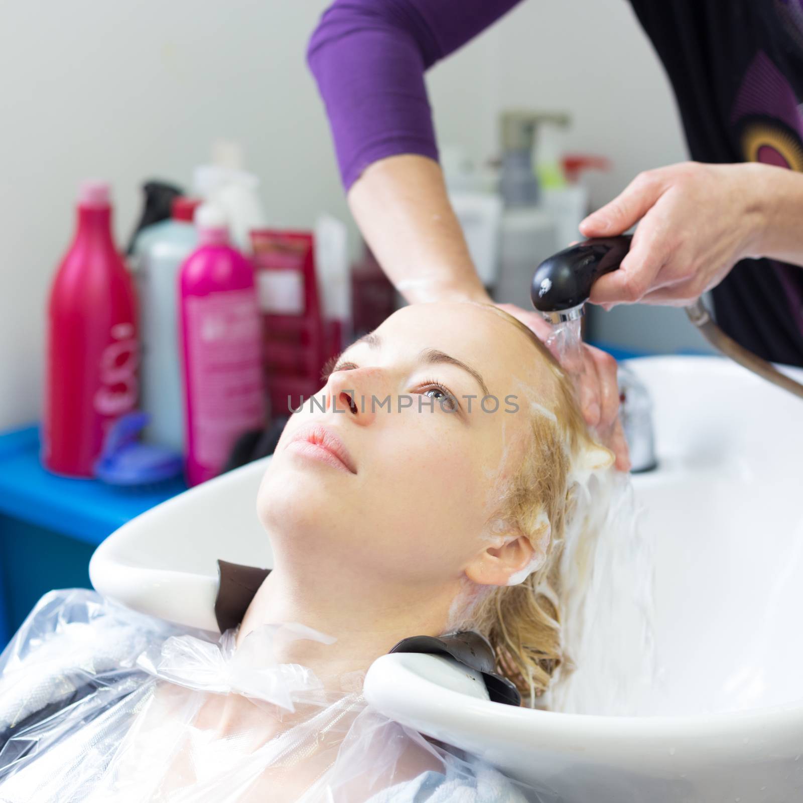 Hairdresser salon. Woman during hair wash process.