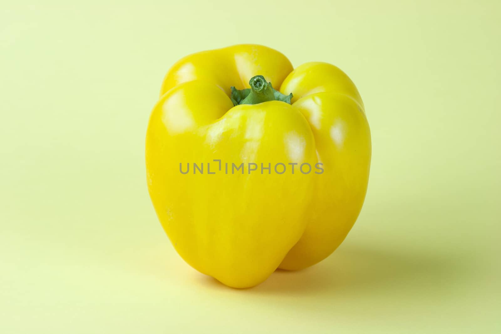 Sweet yellow pepper isolated on yellow background by stefanoventuri