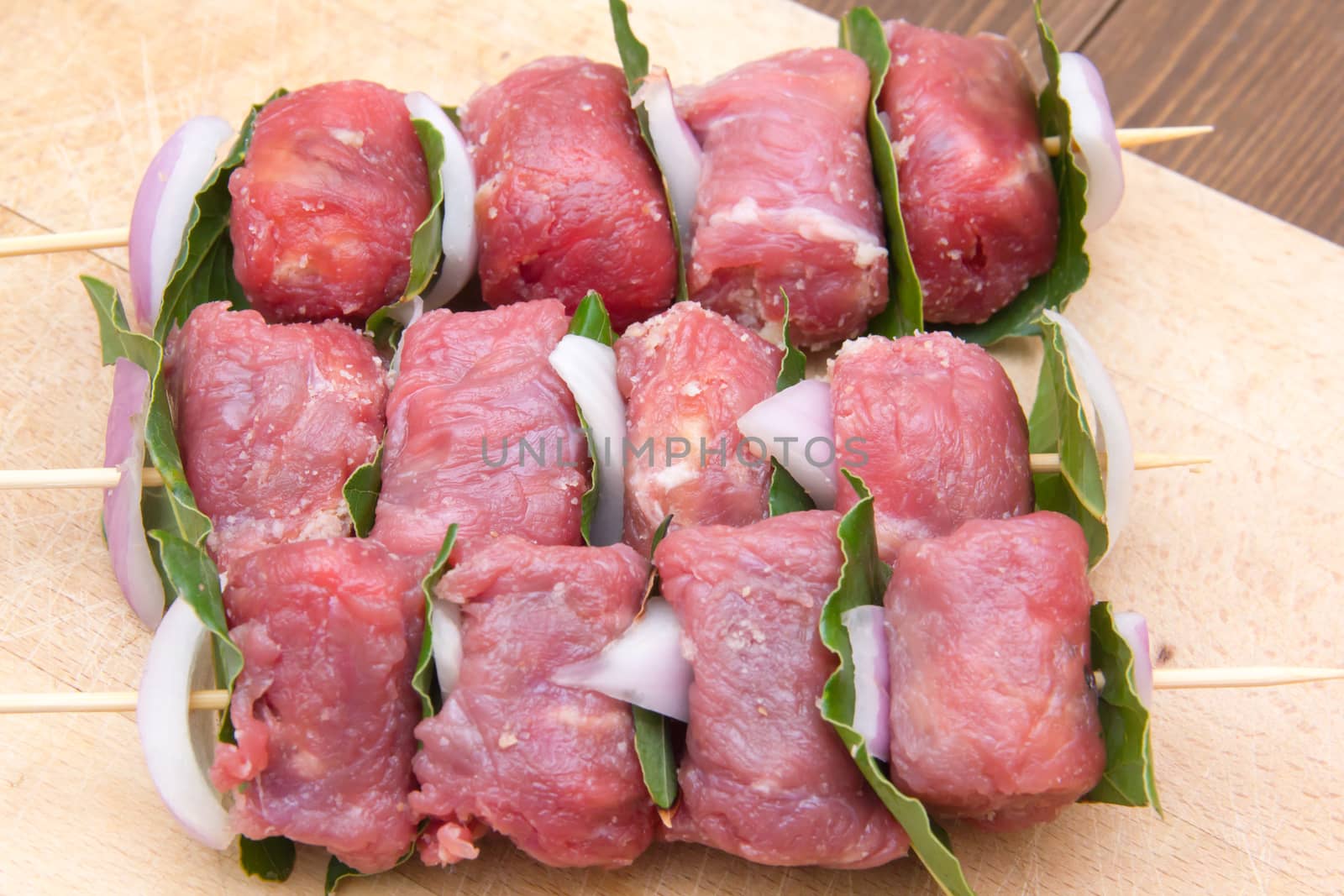 Skewers of meat on cutting board