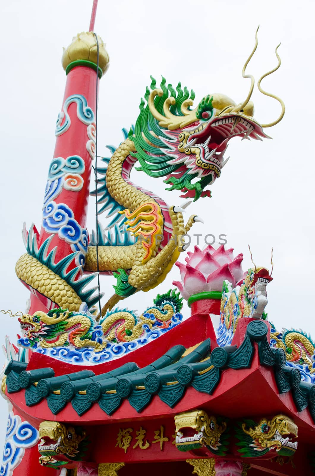 Dragon winding around the pole in chinese shrine in Thailand