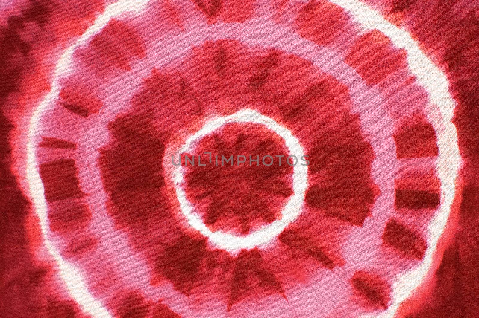 red abstract pattern on tie dyed cotton fabric