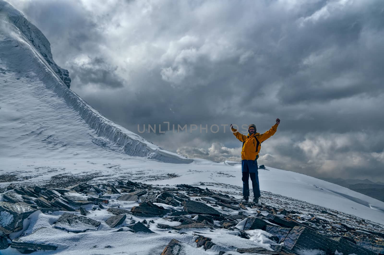 Happy young mountaineer spreading arms in Pamir mountains in Tajikistan