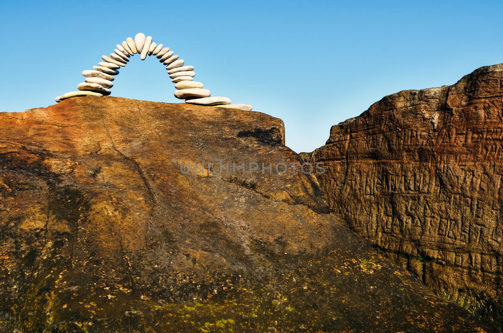 Arch of pebbles on the top of the rock
