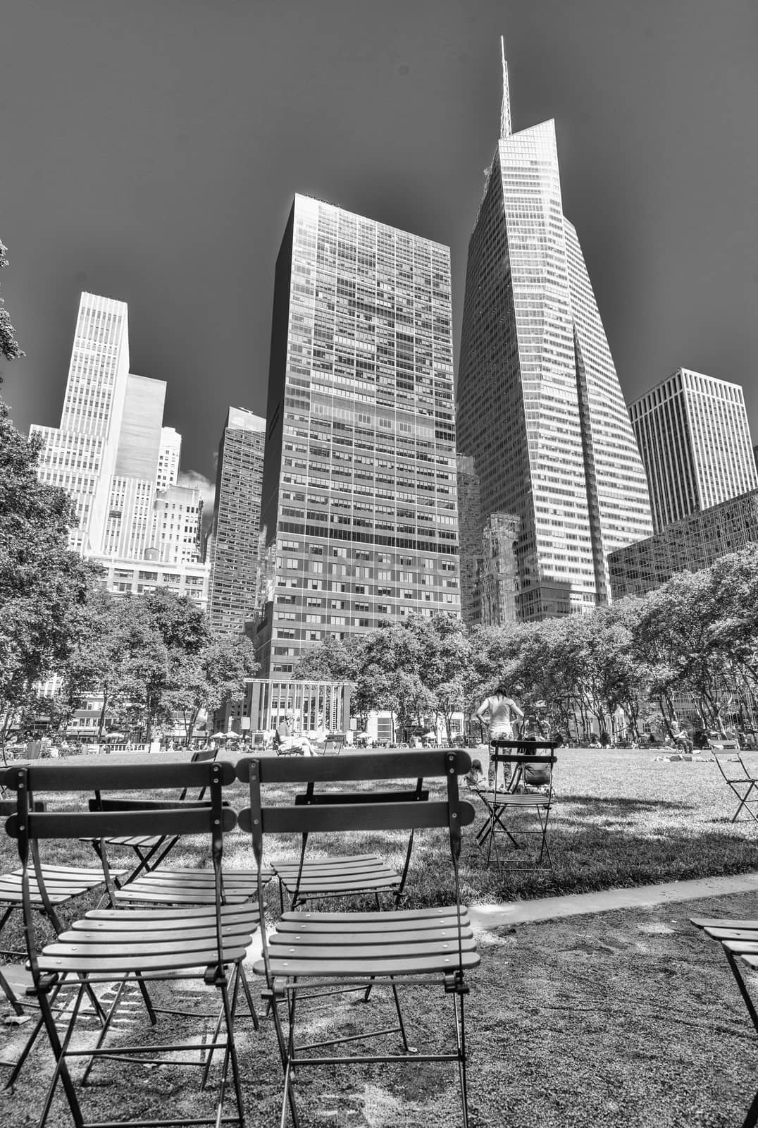 NEW YORK CITY - JUNE 11, 2013: Locals and tourists relax in Bryant Park. New York attracts more than 50 million people annually.