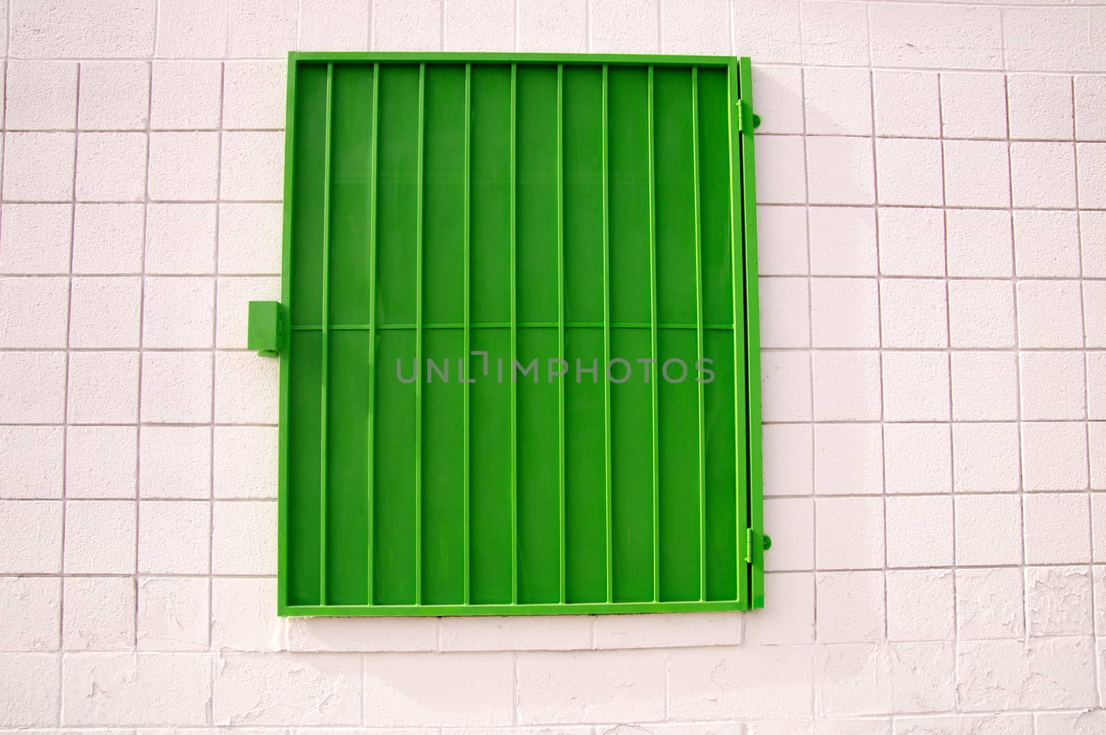 Green mesh shutter on white wall by emattil