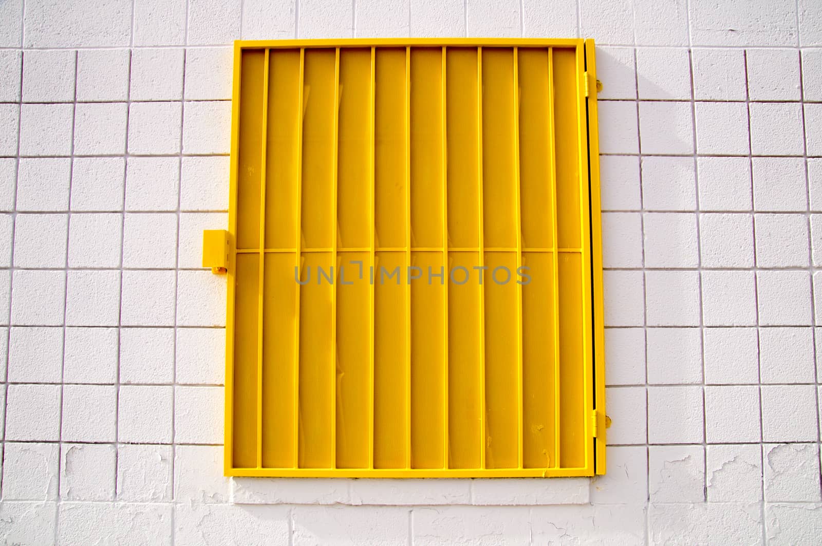 Urban design yellow shutter on white wall