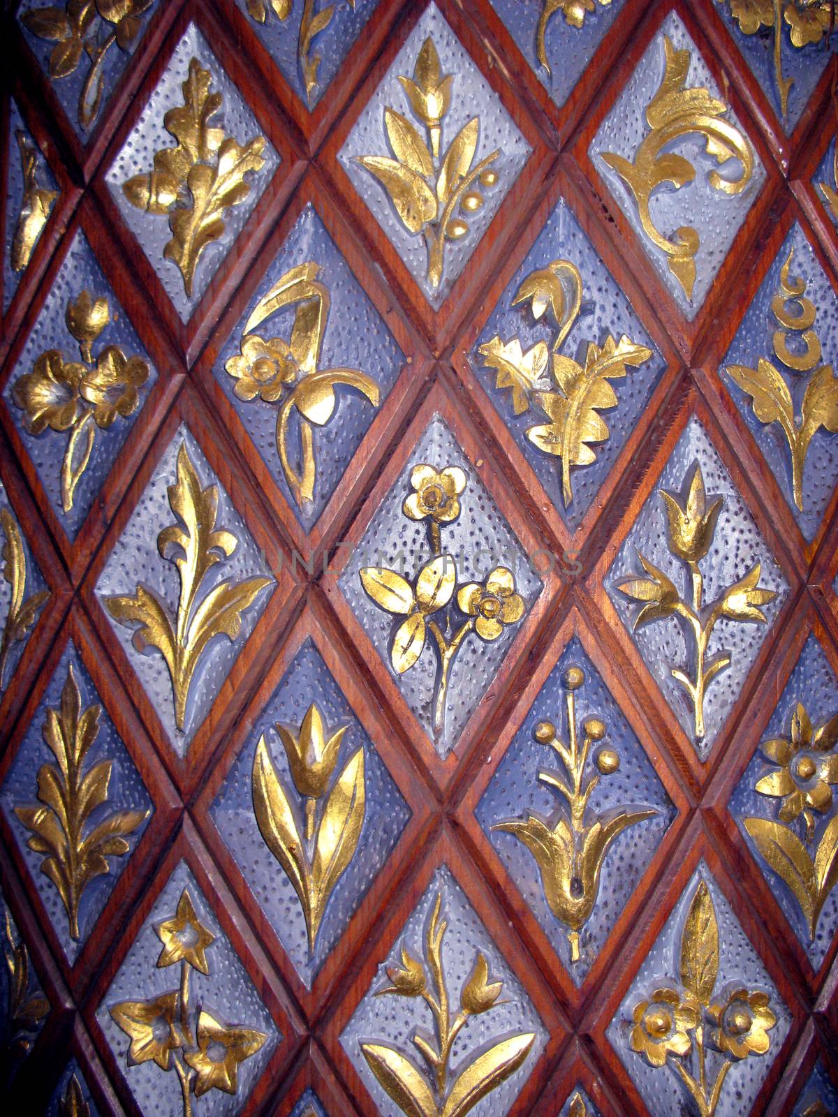 Close up of carved golden flowers on church door