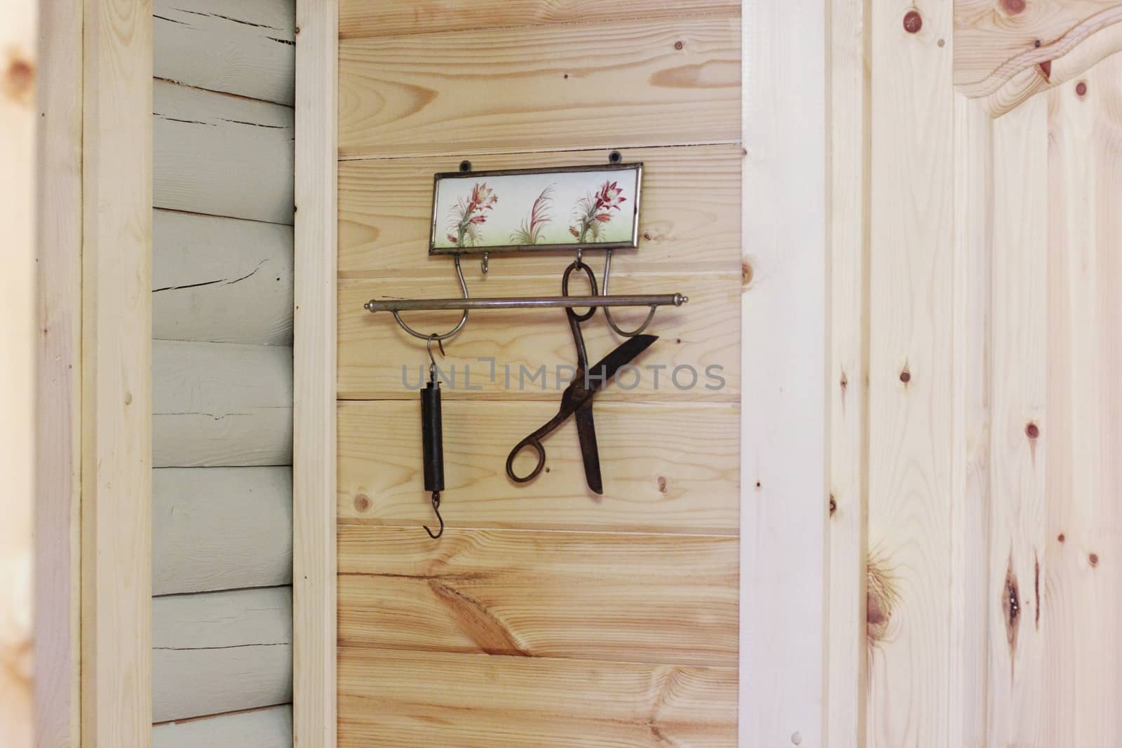 Vintage composition on the background of a wooden wall. Hanger, scissors, scales