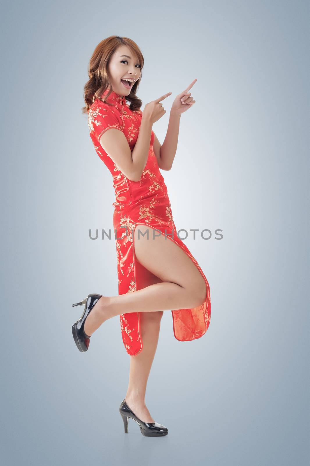 Chinese woman dress traditional cheongsam at New Year and introducing, full length portrait isolated.