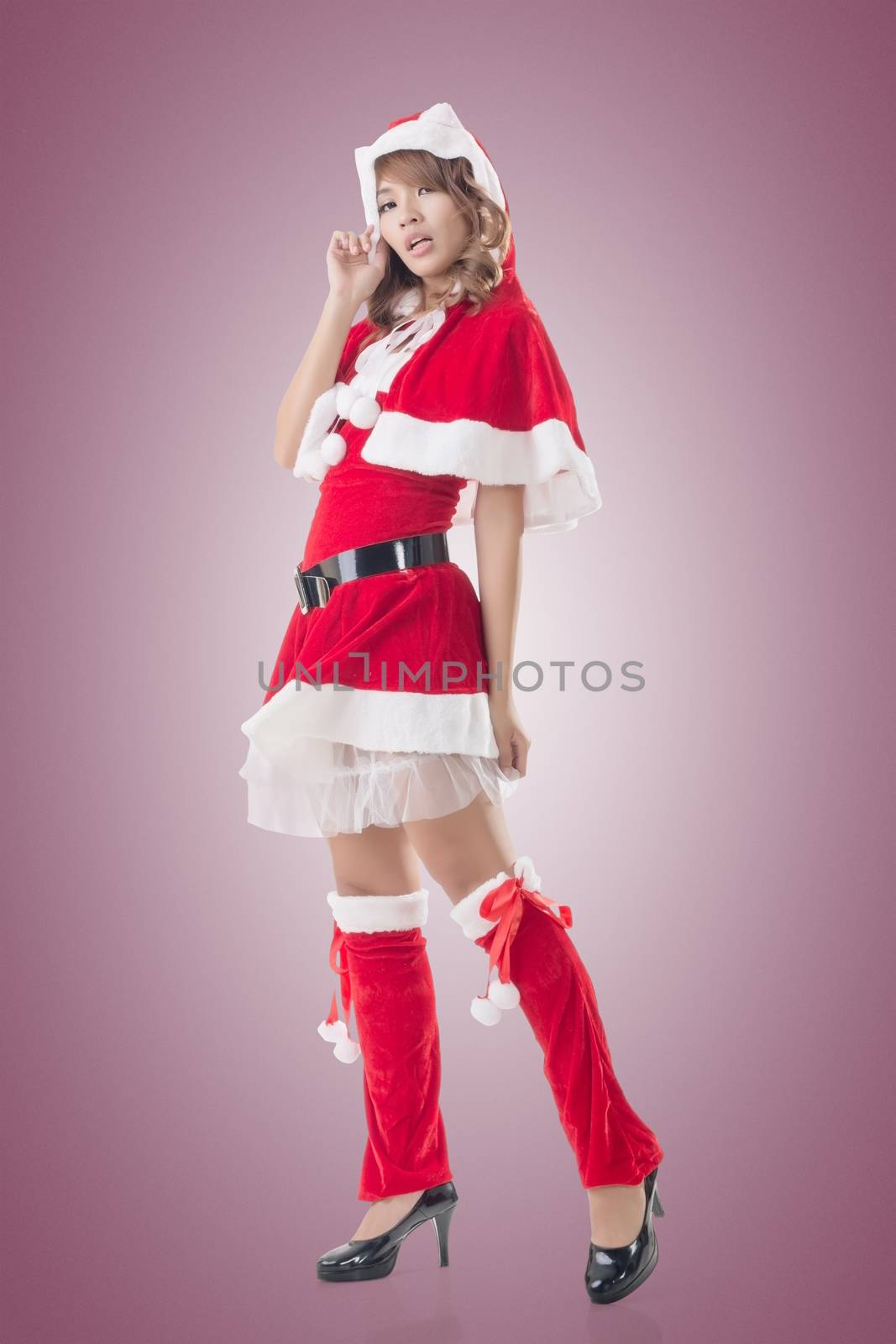 Sexy Christmas girl of Asian standing and smiling at the studio, full length portrait isolated.