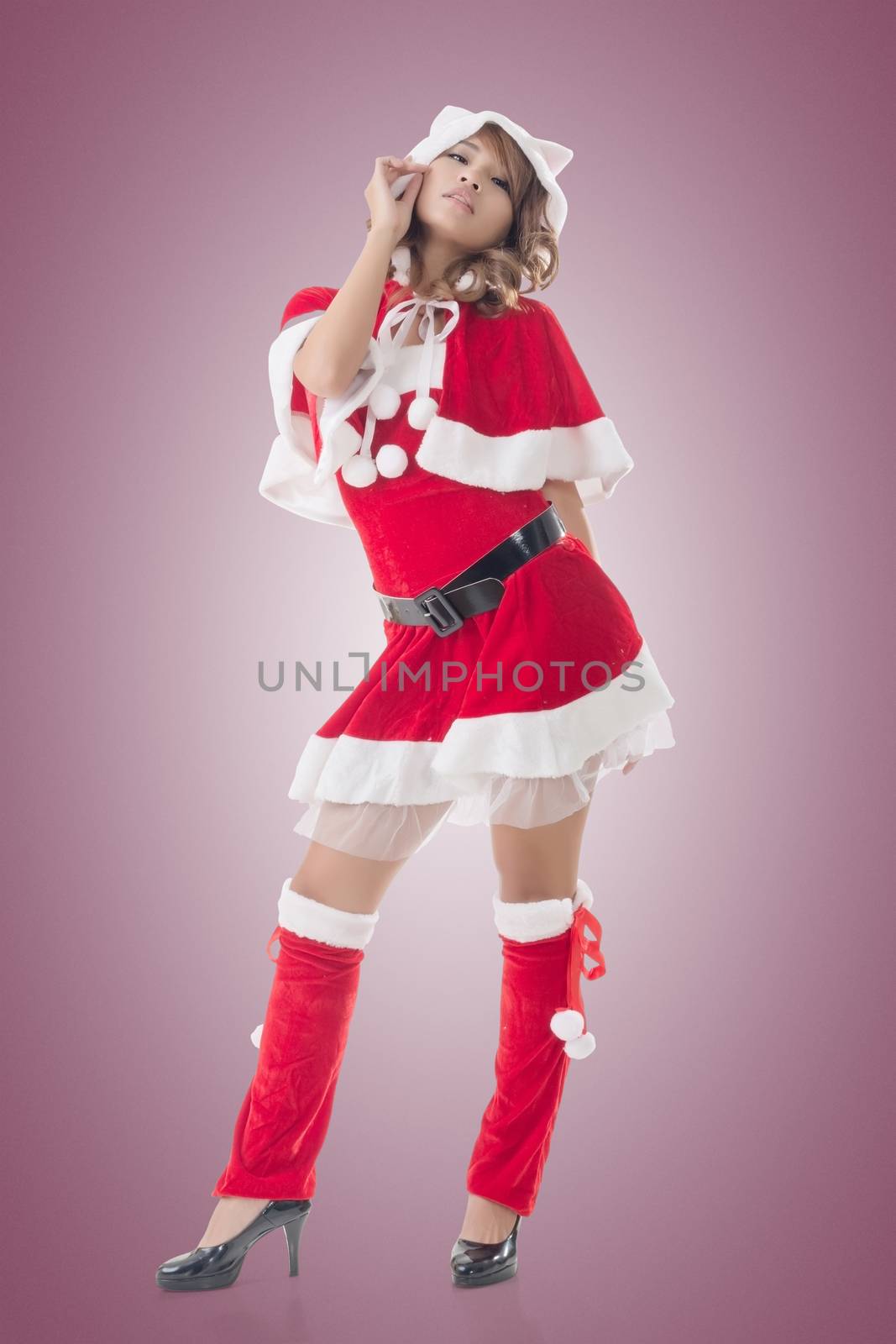 Sexy Christmas girl of Asian standing and smiling at the studio, full length portrait isolated.