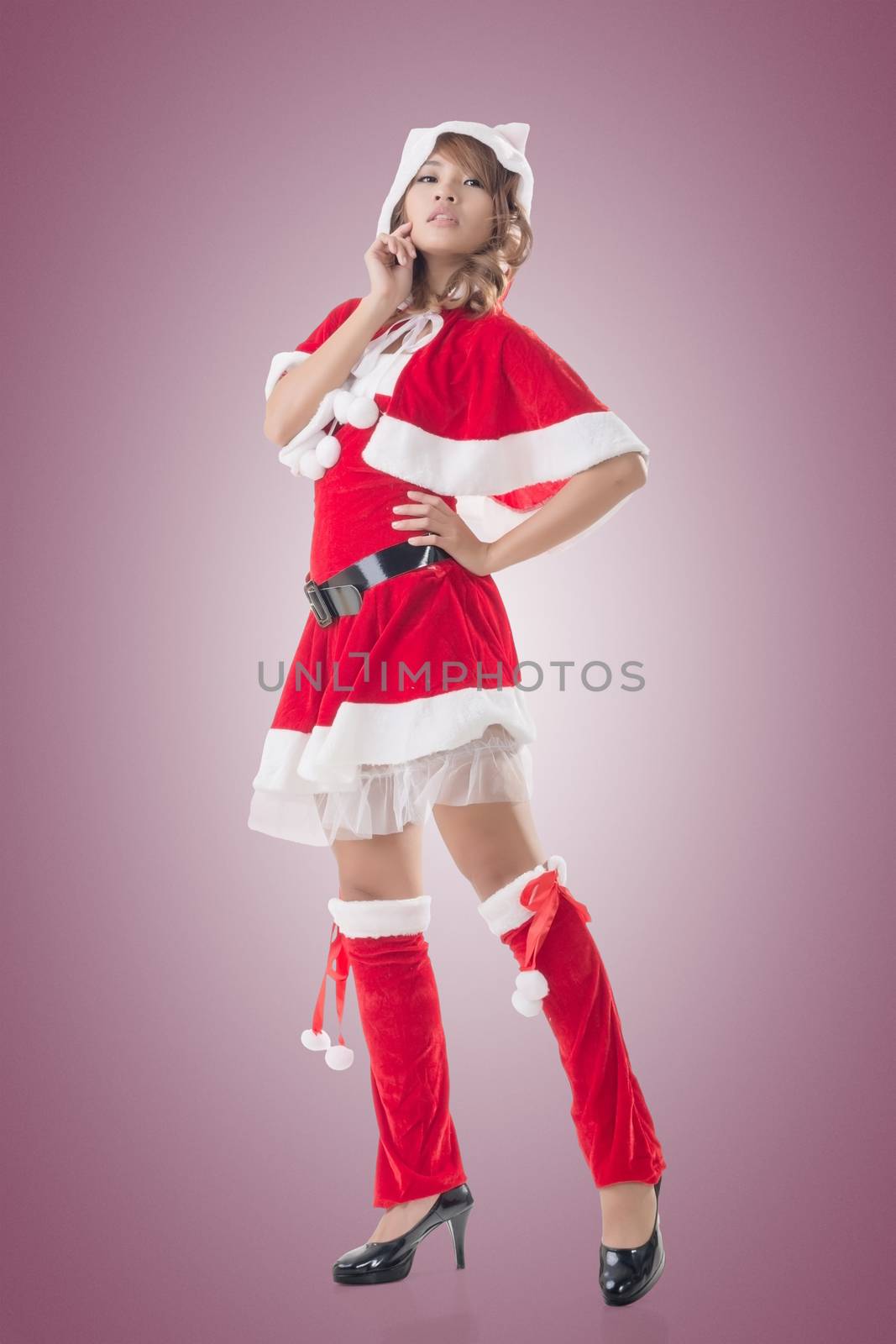 Sexy Christmas girl of Asian standing and smiling at the studio, full length portrait isolated.