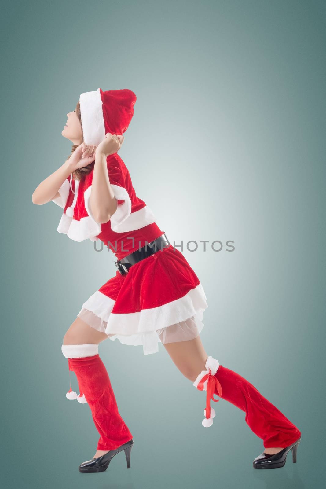 Christmas girl pull something, full length portrait.