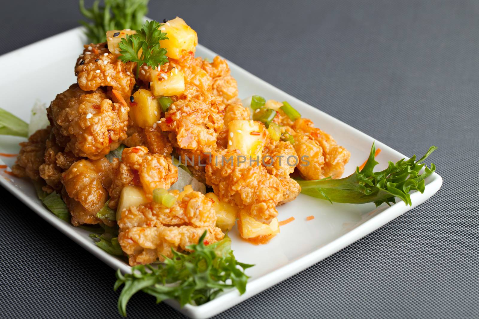 Thai fried calamari appetizer with fresh pineapple chunks.
