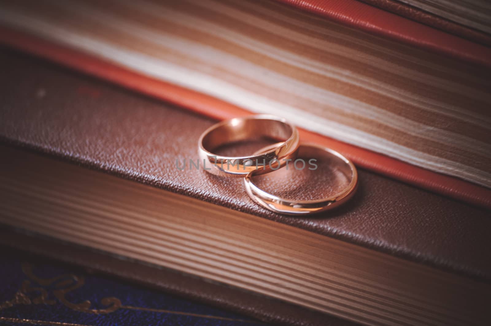 two wedding rings on top of books 