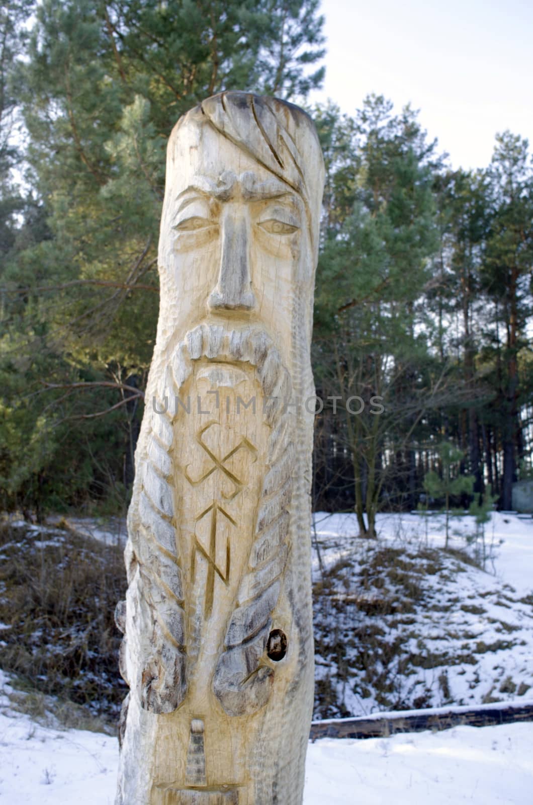totem wood pole in the blue cloudy background  by dolnikow