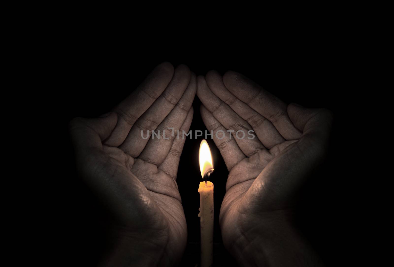 Candle light in hand, Hope concept by pixbox77