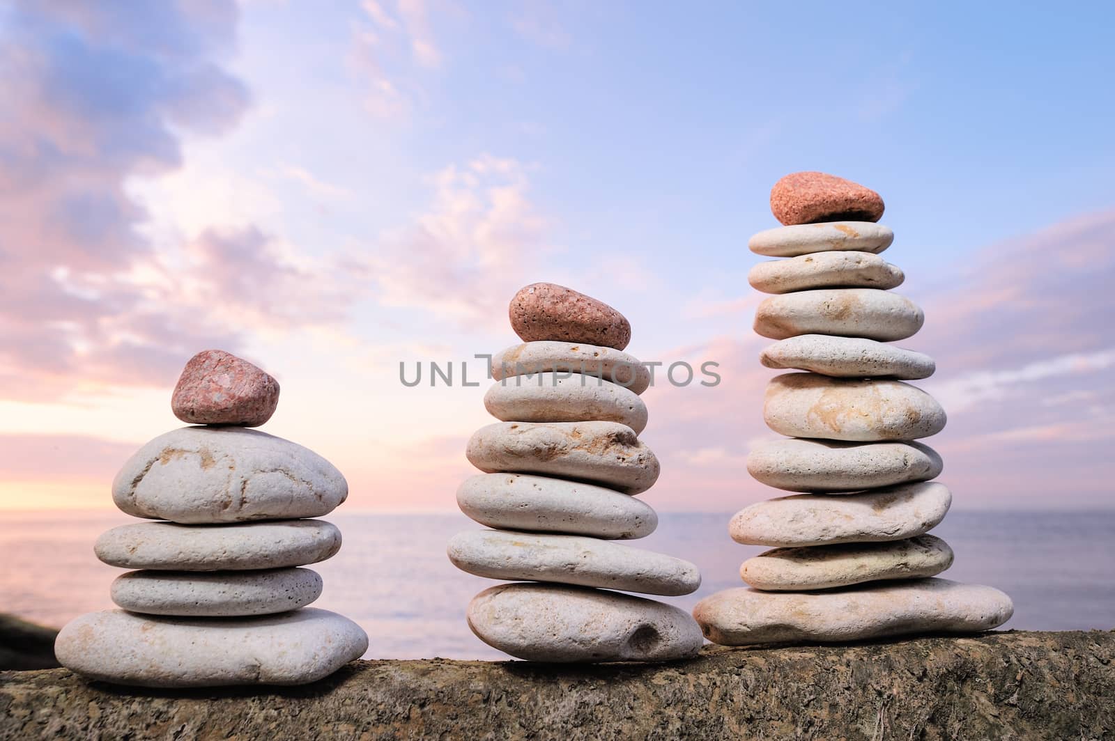 Red stones on the top of the three piles of white pebbles