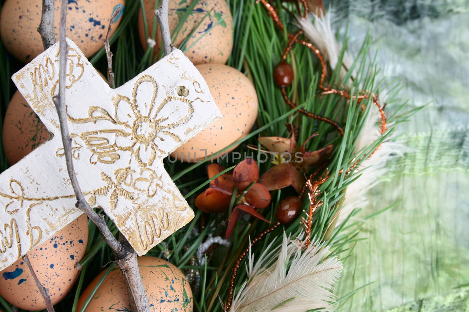 Easter wreath with eggs and decorations on green cloth