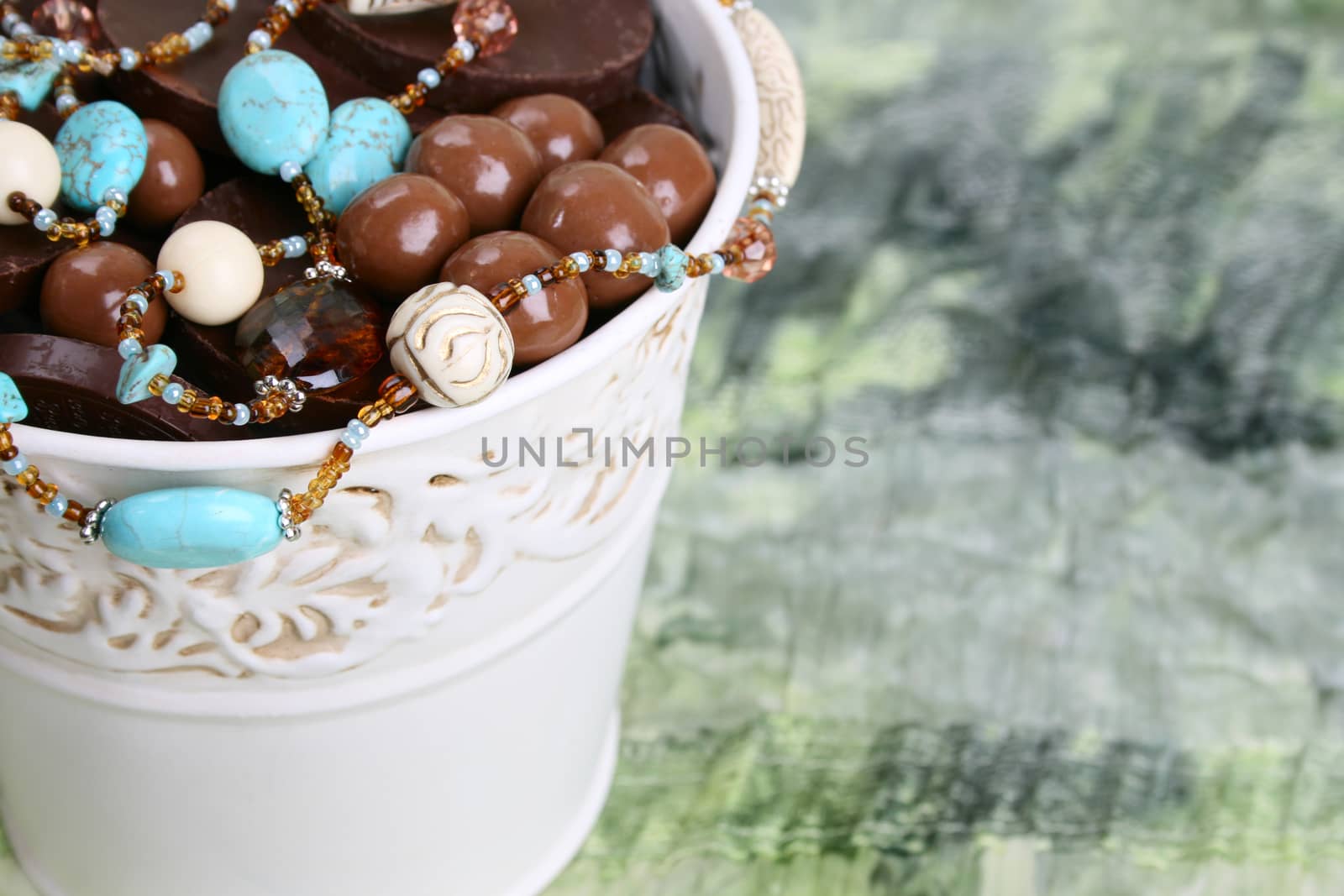 Ornate bucket filled with chocolates and beads