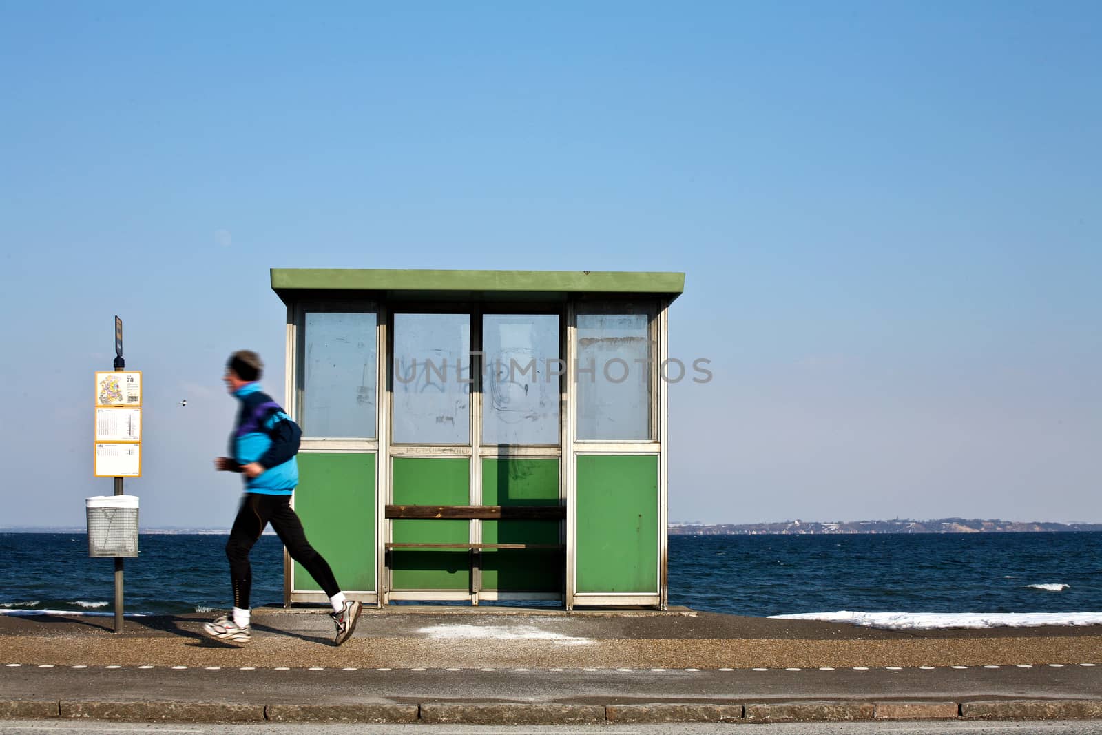 View of the danish east coast bus stop and man running