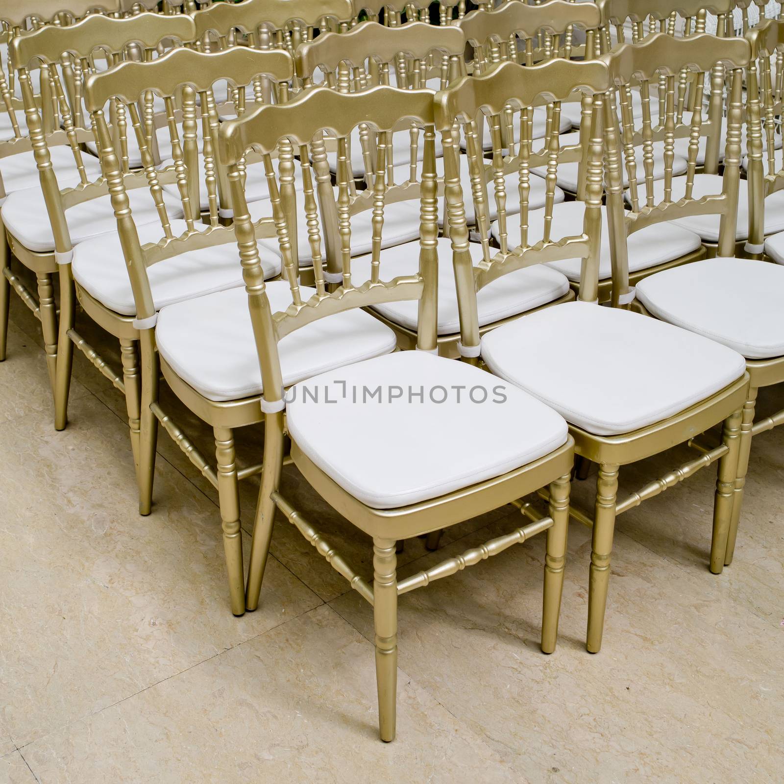 Rows of gold chairs - meeting background by art9858