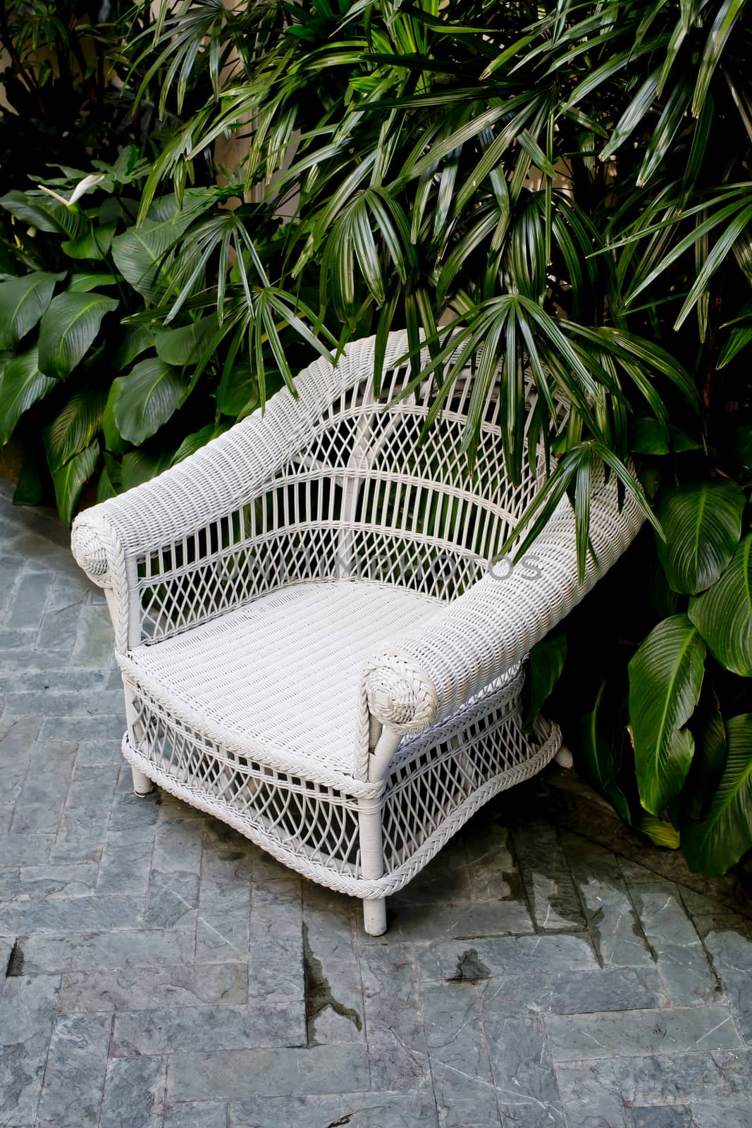 Rattan chair with green trees at outdoor