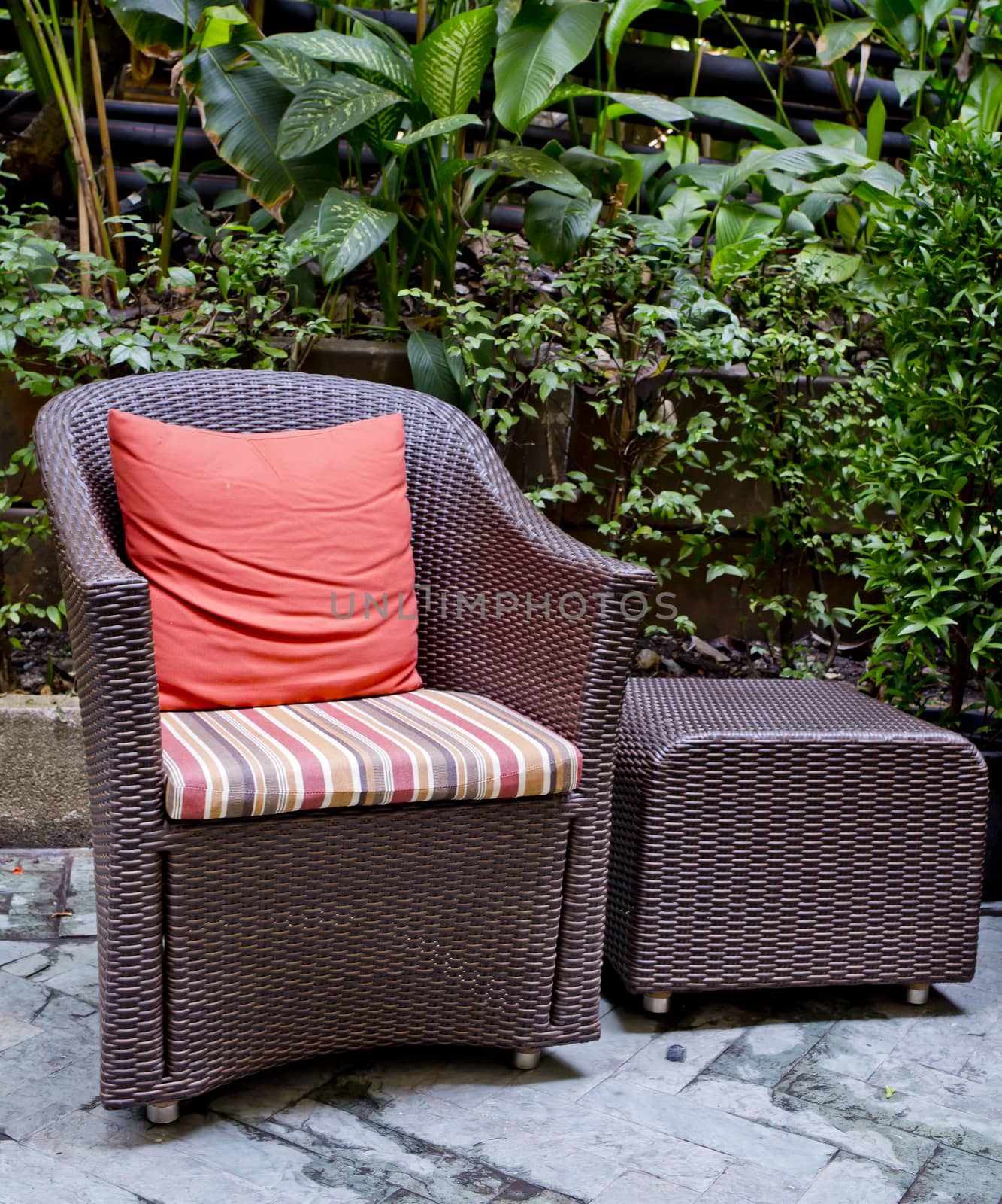 Rattan chair and rattan coffee table with green trees at outdoor