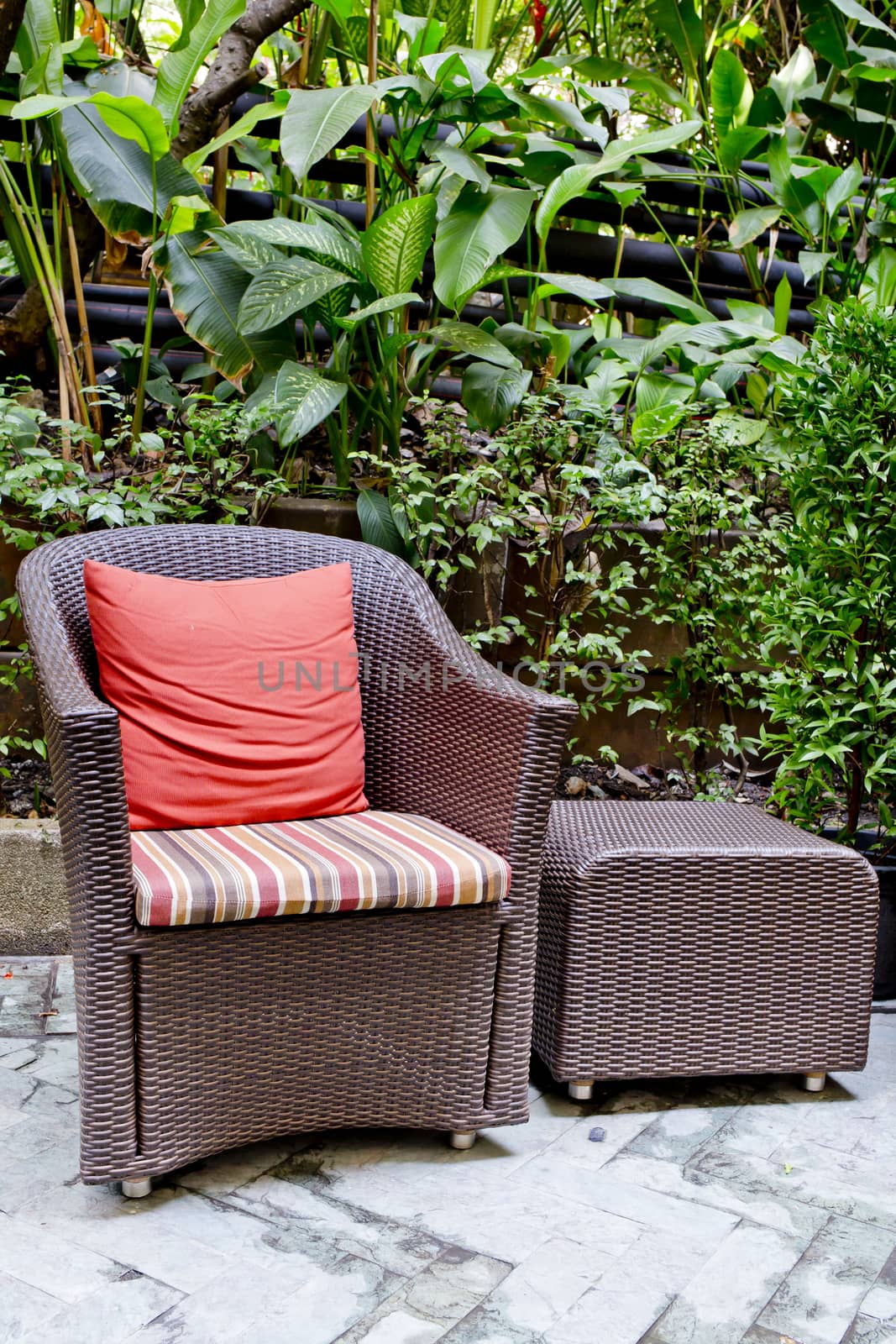 Rattan chair and rattan coffee table with green trees at outdoor by art9858