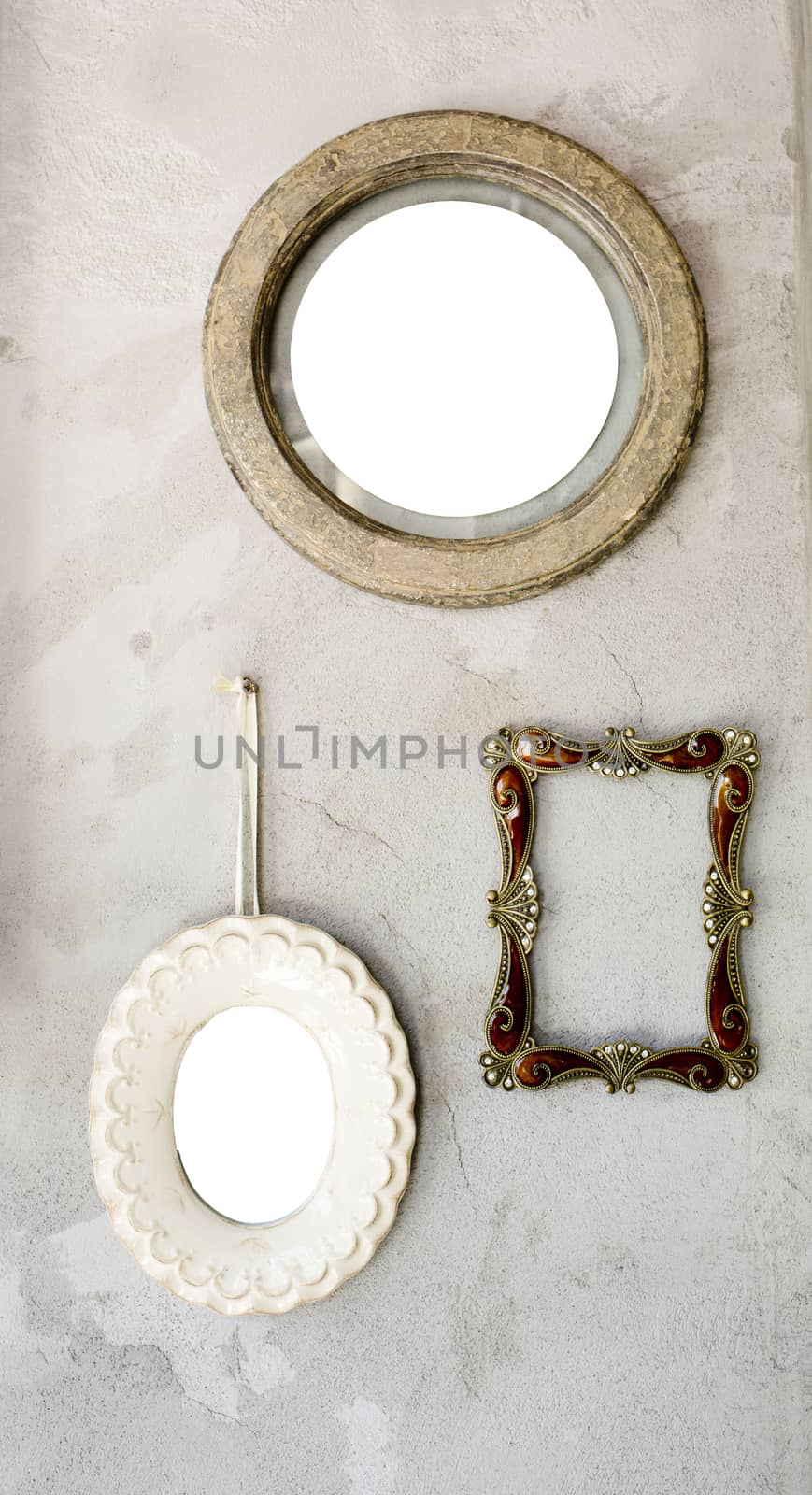 Set of different modern and ancient mirrors and photo frame.