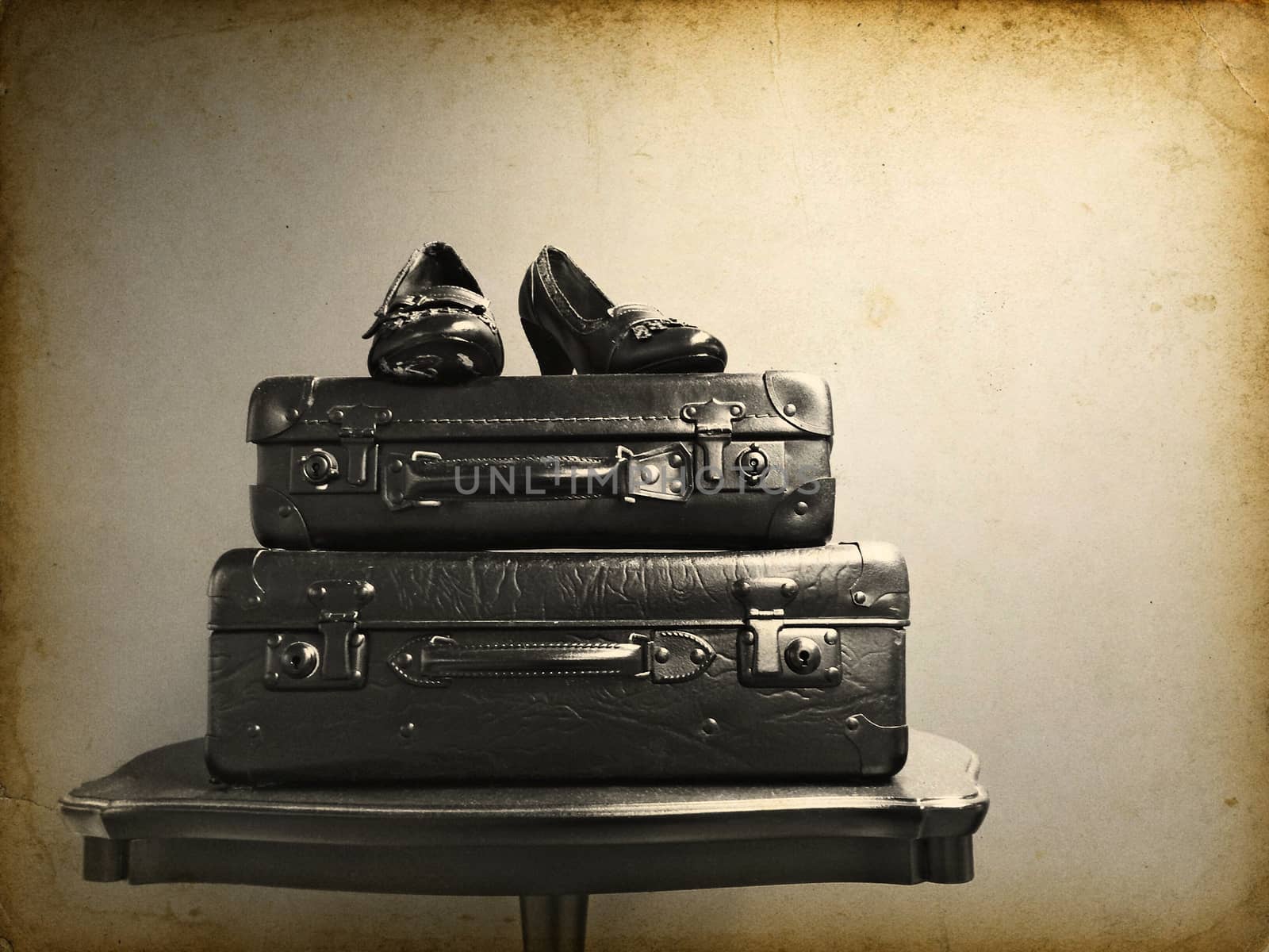 Vintage suitcases and shoes on a table. Retro style photo.