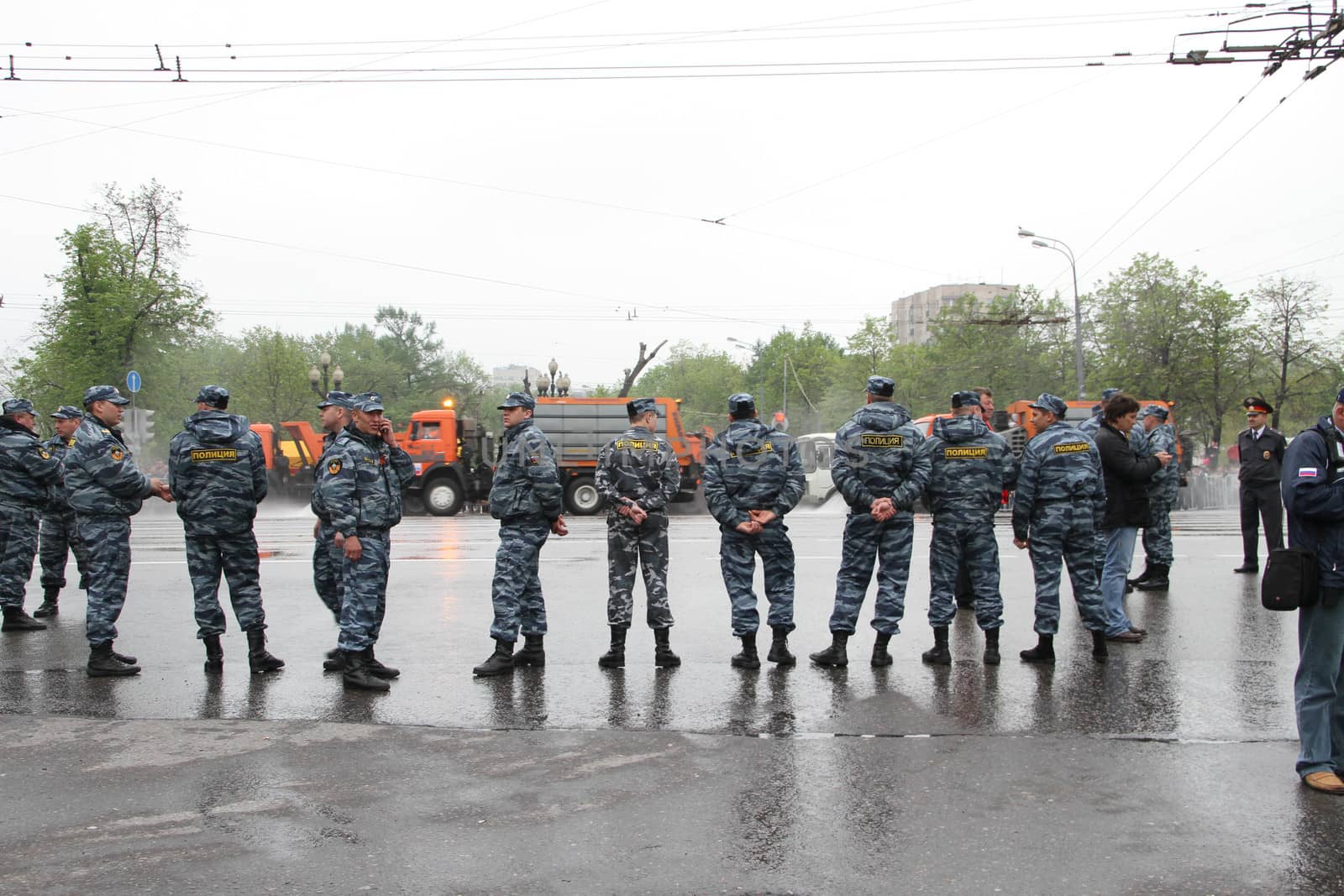 Moscow, Russia - May 9, 2012. March of communists on the Victory Day. Staff of the Russian police protects political procession