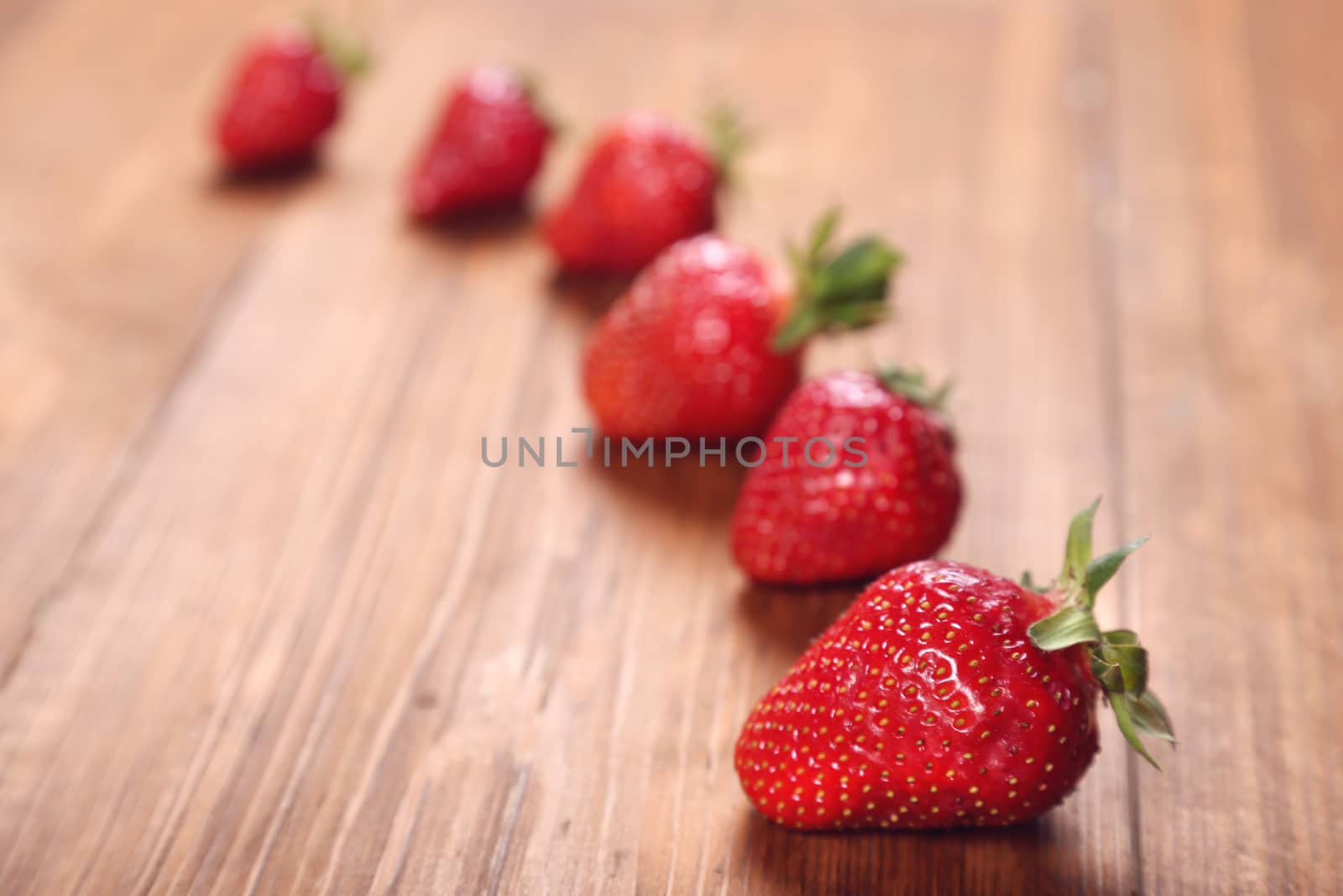 row red ripe,fresh strawberry on a wooden background