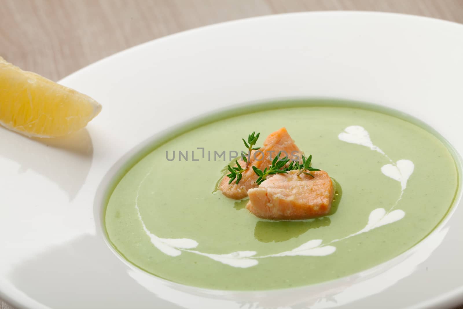 Green broccoli cream soup puree with filleted salmon  and  lemon by SergeyAK