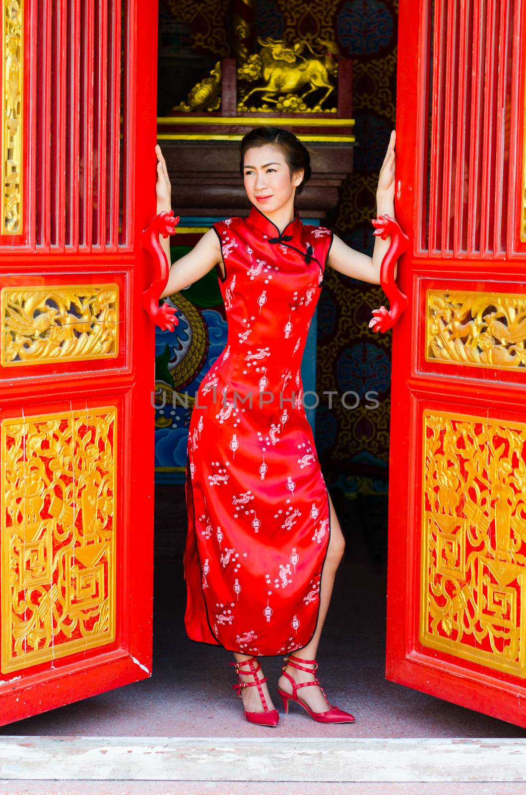 Chinese woman in red dress traditional, Cheongsam. by chatchai