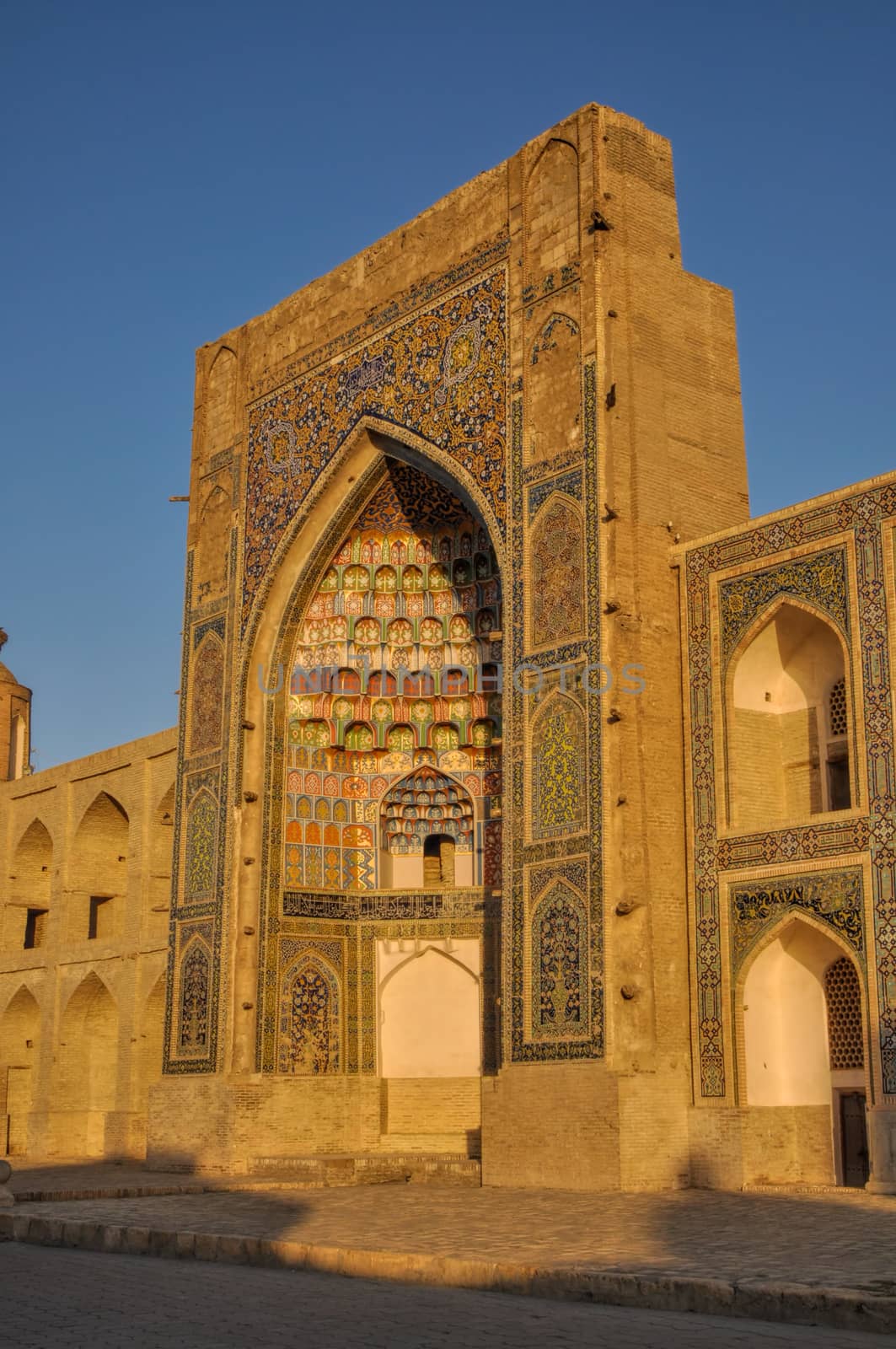 Side-view of the Abdulaziz Khan Madrassah (Museum of Wood Carving Art) in the setting sun, Uzbekistan