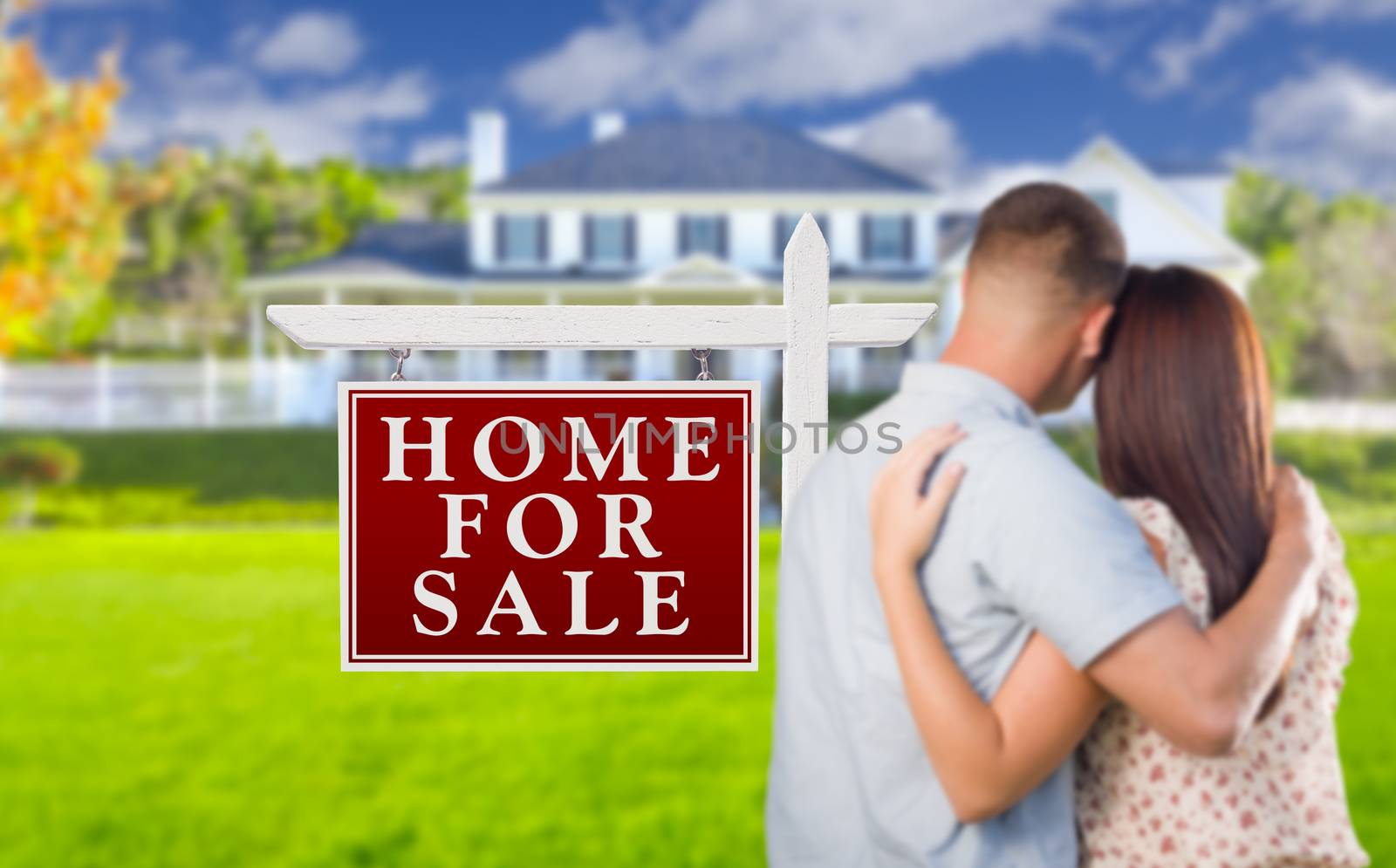 For Sale Real Estate Sign and Affectionate Military Couple Looking at Nice New House.