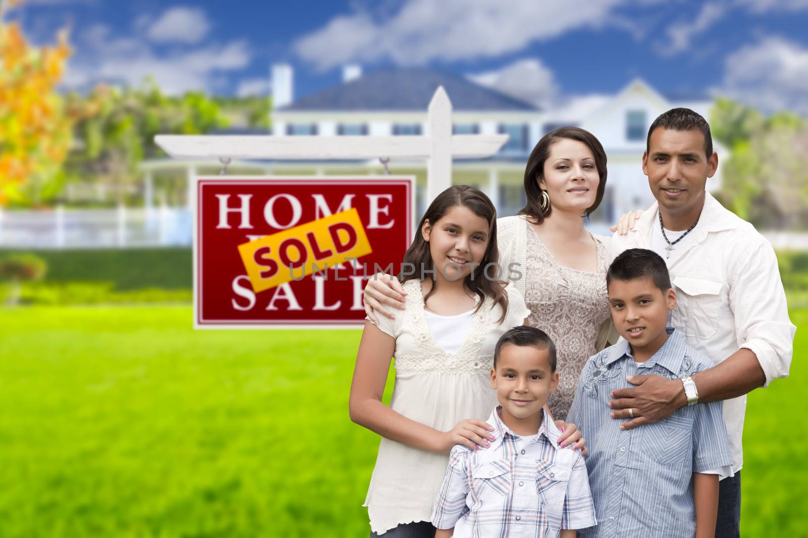 Hispanic Family in Front of Sold Real Estate Sign, House by Feverpitched