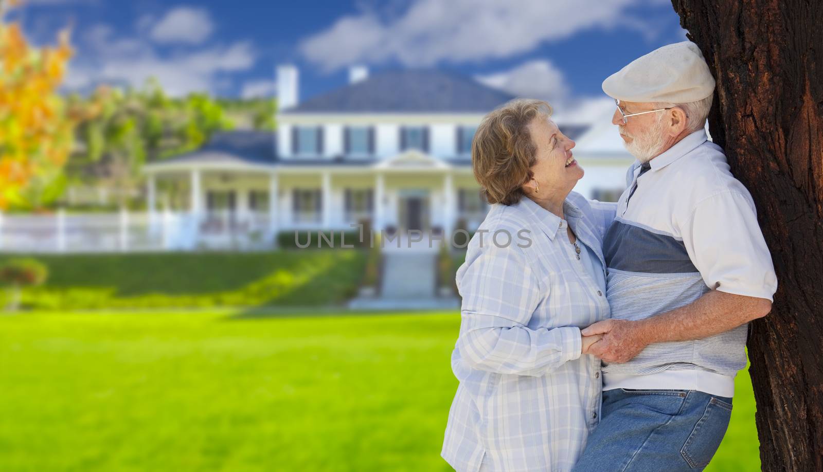 Happy Senior Couple in the Front Yard of Their House.